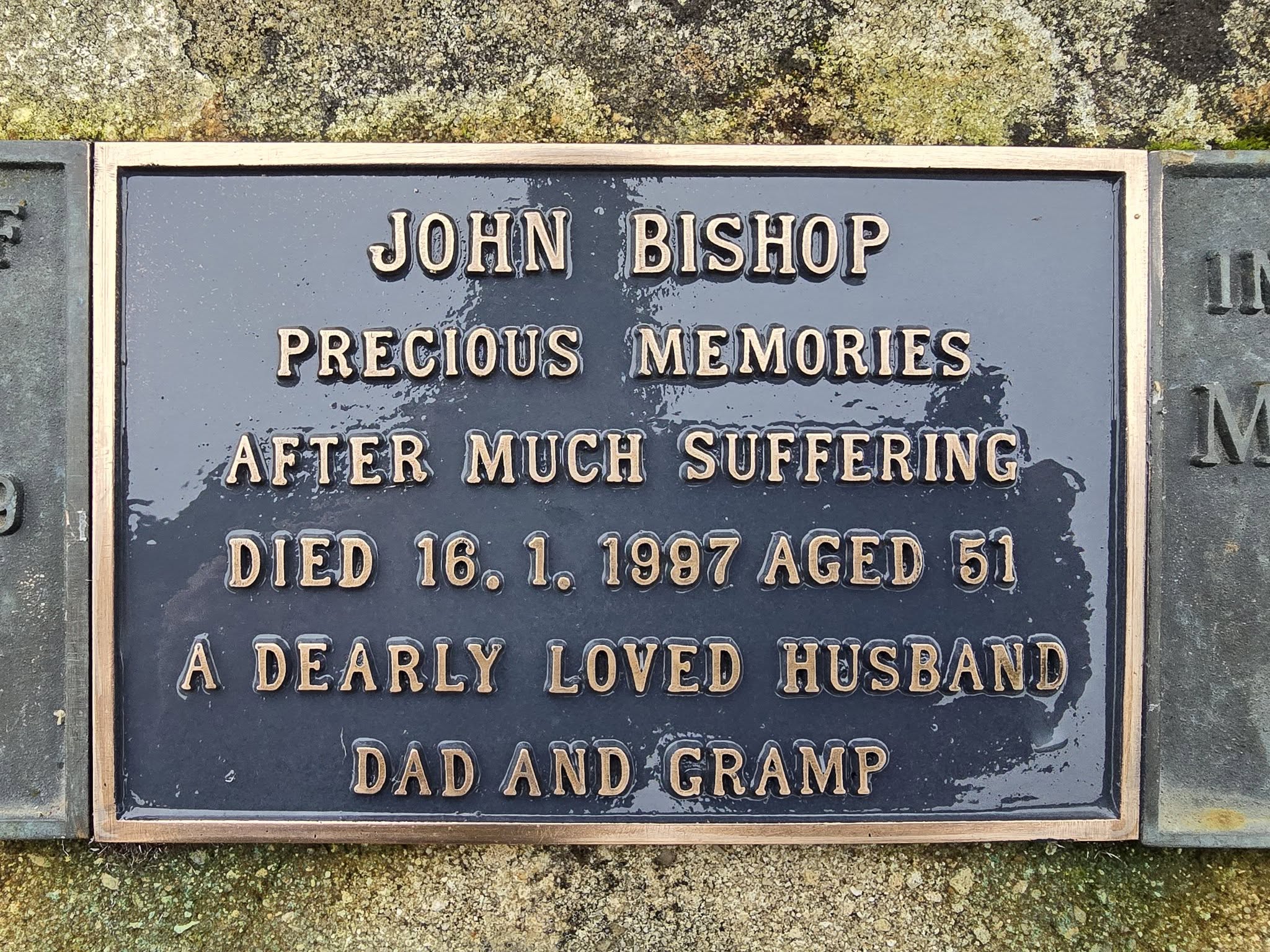 A memorial plaque for John Bishop, noting his death on 16 January 1987 at age 51, and describing him as a dearly loved husband, dad, and gramp.