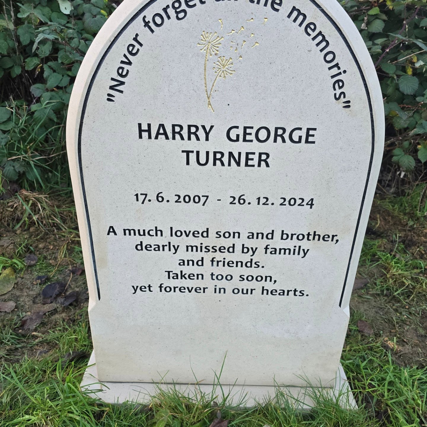 A gravestone reads: "Never forget all the memories. HARRY GEORGE TURNER 17.6.2007 - 26.12.2024. A much loved son and brother, dearly missed. Taken too soon, yet forever in our hearts.